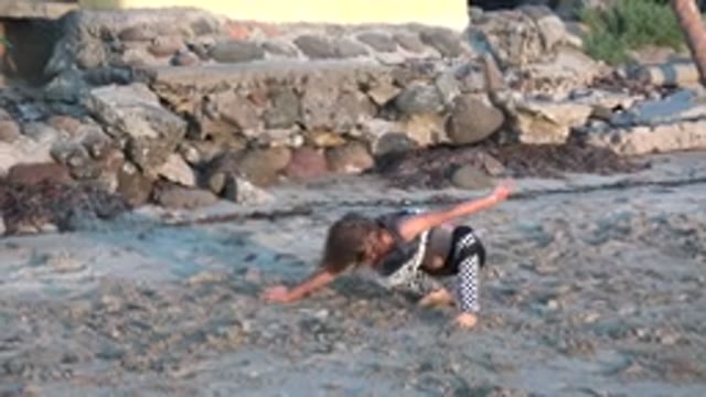 SAN CARLOS BCS MEXICO-2022: Girl Performing Dance Moves on Sandy Beach