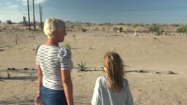 SAN CARLOS BCS MEXICO-2022: People Walking in Desert with Power Lines and Sky