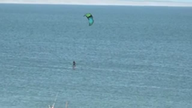 SAN JUANICO BCS MEXICO-2022: Kite Surfer Gliding Across Calm Ocean Waters
