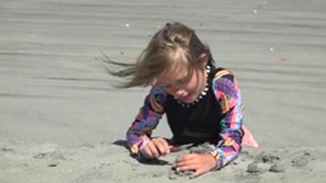 LA BOCANA BCS MEXICO-2022: Child Building Sandcastles on Sandy Beach