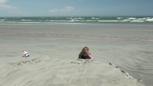 LA BOCANA BCS MEXICO-2022: Child Partially Buried in Sand on Beach