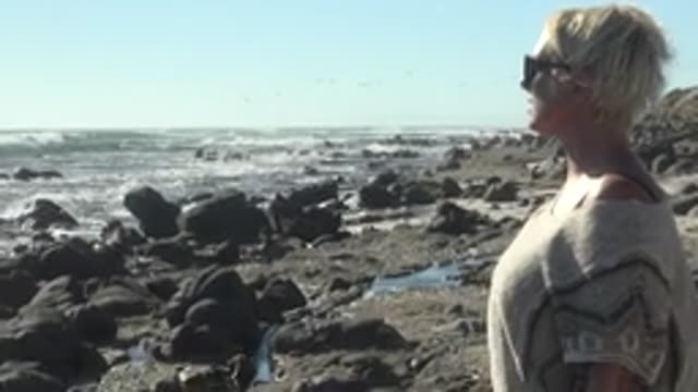 LA BOCANA BCS MEXICO-2022: Woman on Rocky Shore Observing Ocean Waves