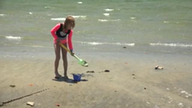 SAN CARLOS BCS MEXICO-2022: Child Digging Sand with Shovel and Bucket on Beach