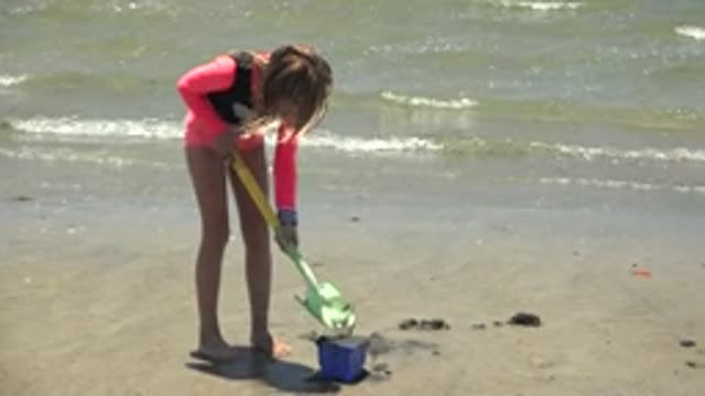 SAN CARLOS BCS MEXICO-2022: Girl Playing with Sand Shovel on Beach