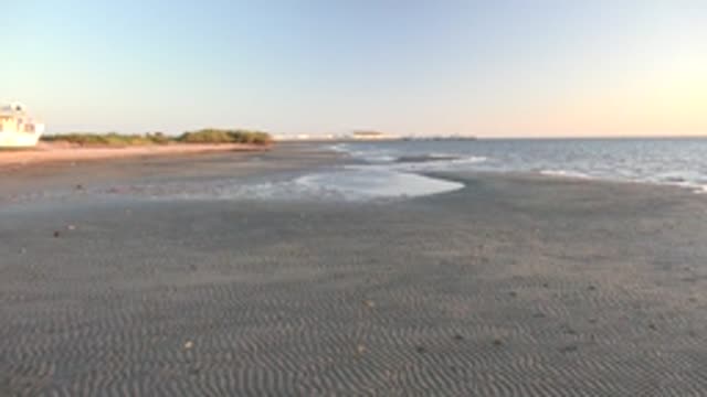 SAN CARLOS BCS MEXICO-2022: Boat Moving Out of Frame on Sandy Beach