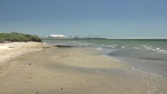 SAN CARLOS BCS MEXICO-2022: Sandy Beach with Calm Ocean and Distant Structures