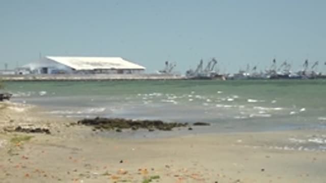 SAN CARLOS BCS MEXICO-2022: Sandy Beach with Gentle Waves and Harbor Structures