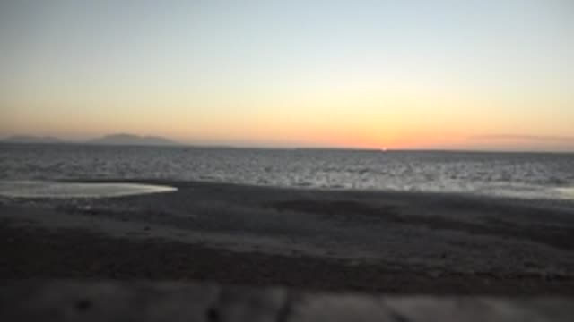 SAN CARLOS BCS MEXICO-2022: Beach at Sunset with Calm Ocean and Distant Islands