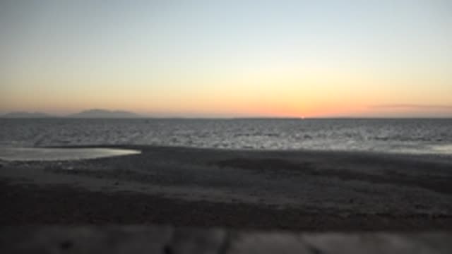 SAN CARLOS BCS MEXICO-2022: Sunset Over Calm Ocean and Sandy Shore