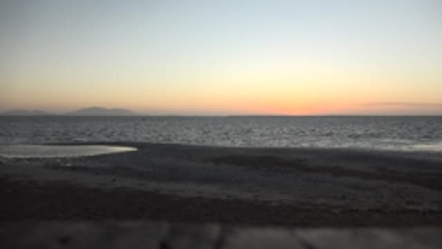 SAN CARLOS BCS MEXICO-2022: Calm Ocean Waves at Dusk on a Sandy Beach