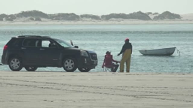 LA BOCANA BCS MEXICO-2022: Beachgoers with Car and Boat on Sandy Shore