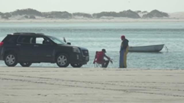 LA BOCANA BCS MEXICO-2022: Beachgoers Fishing Near Parked Car and Boat