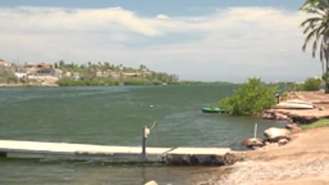 MULEGE BCS MEXICO-2022: Calm Lake Dock with Shifting Shore and Distant Houses