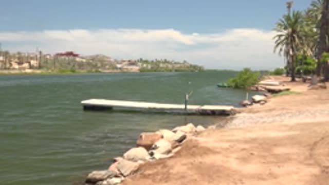 MULEGE BCS MEXICO-2022: Calm River with Dock and Distant Shoreline Buildings