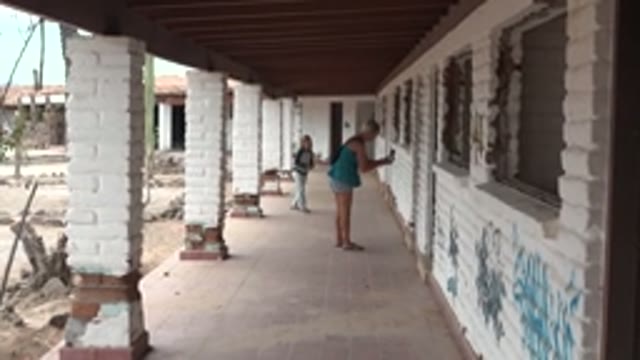 MULEGE BCS MEXICO-2022: Woman and Child Moving Along a White Brick Walkway