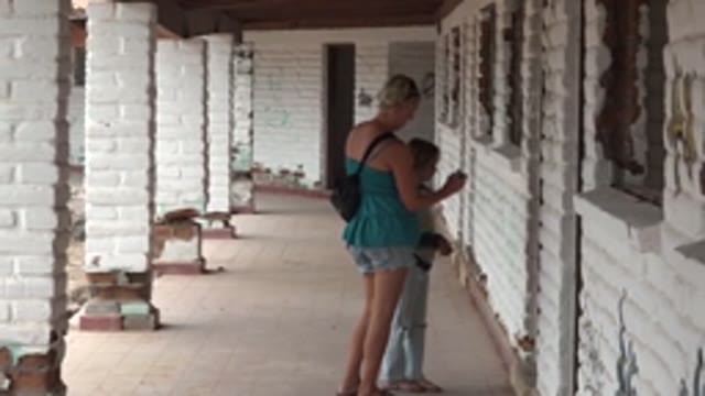 MULEGE BCS MEXICO-2022: Woman and Child Exploring a Brick Corridor