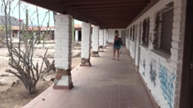 MULEGE BCS MEXICO-2022: People Walking Along a Weathered Building Corridor