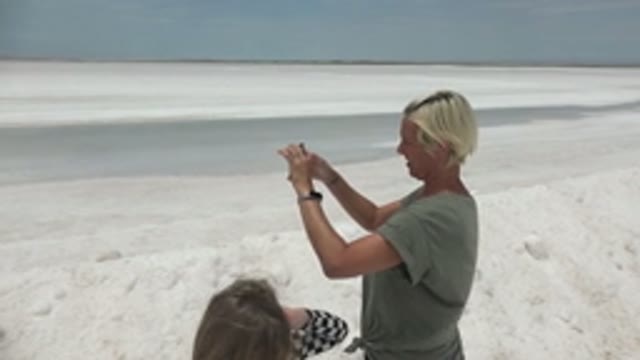 GUERRERO NEGRO BCS MEXICO-2022: Two People Photographing on a White Sandy Beach
