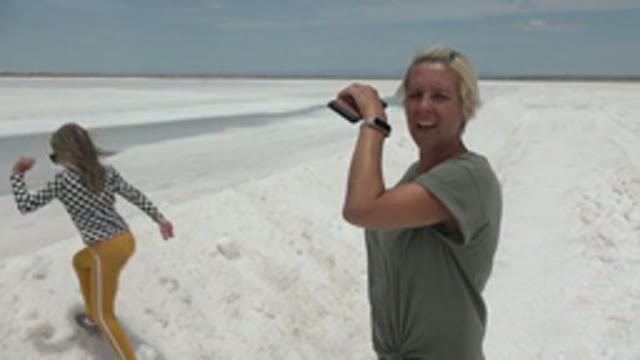 GUERRERO NEGRO BCS MEXICO-2022: Two People Taking Photos on a White Salt Flat