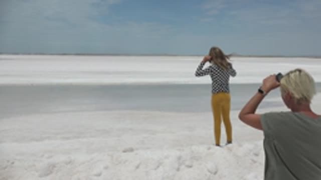 GUERRERO NEGRO BCS MEXICO-2022: Two People Taking Photos on a White Flat Snowy Area