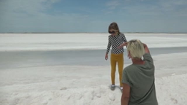 GUERRERO NEGRO BCS MEXICO-2022: Child and Adult Interacting on White Salt Flat