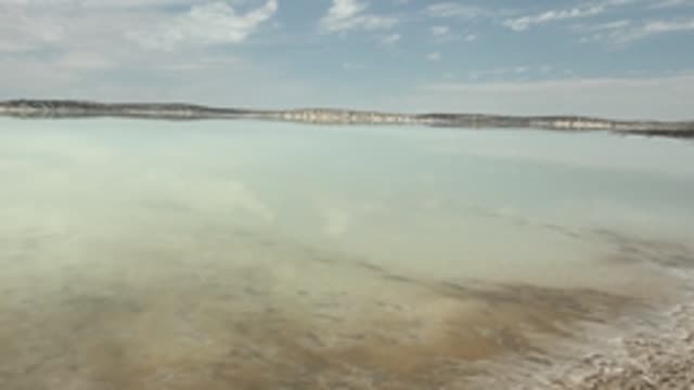 GUERRERO NEGRO BCS MEXICO-2022: Shifting Clouds Reflect on Calm Salt Lake Surface
