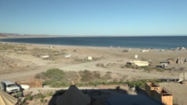 SAN JUANICO BCS MEXICO-2022: Beach with Van Driving Past