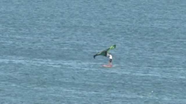 SAN JUANICO BCS MEXICO-2022: Kite Surfer Gliding Across Calm Ocean Waters