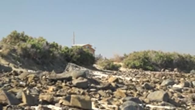 LA BOCANA BCS MEXICO-2022: Rocky Shore with Distant House and Vegetation