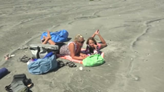LA BOCANA BCS MEXICO-2022: Adult and Child Reading on a Beach Towel