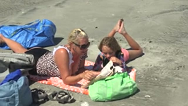 LA BOCANA BCS MEXICO-2022: Woman and Child Reading Book on Beach