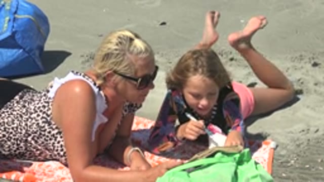 LA BOCANA BCS MEXICO-2022: Woman and Child Engaged with Book on Beach
