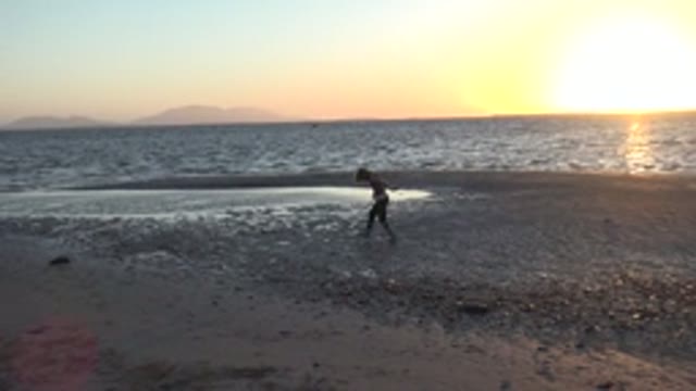 SAN CARLOS BCS MEXICO-2022: Child Walking Along the Beach at Sunset
