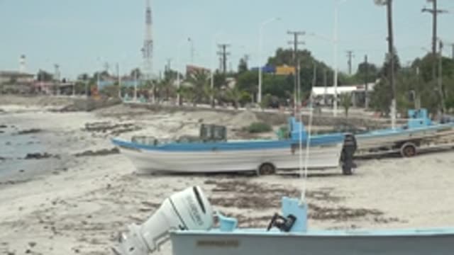 PUENTA ABREOJOS BCS MEXICO-2022: Sandy Beach with Parked Boats and Coastal Structures