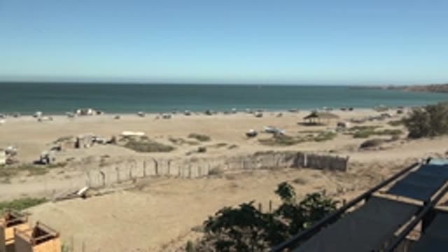 SAN JUANICO BCS MEXICO-2022: Panning View of Beach with Boats and Sandy Shore