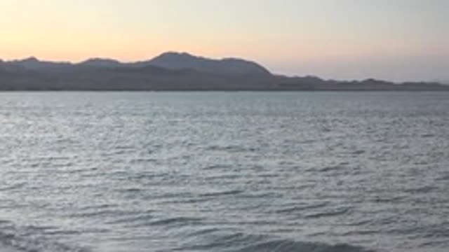 BAHIA DE LOS ANGELES BCS MEXICO-2022: Gentle Ocean Waves Before Mountain Silhouettes at Dusk