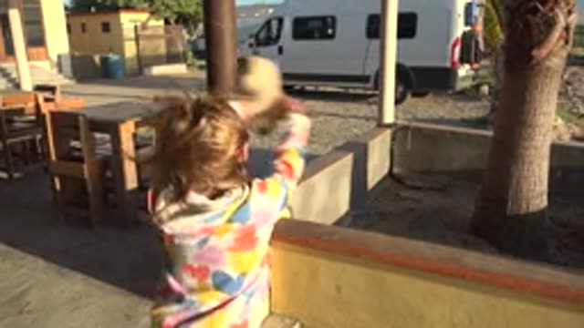 SAN CARLOS BCS MEXICO-2022: Child Playing with a Rabbit on a Patio