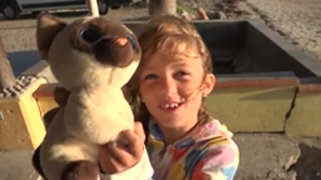 SAN CARLOS BCS MEXICO-2022: Girl Holding Stuffed Animal on Beach Patio
