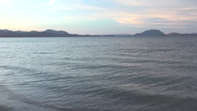 BAHIA DE LOS ANGELES BCS MEXICO-2022: Gentle Ocean Waves and Distant Islands Under Soft Sky