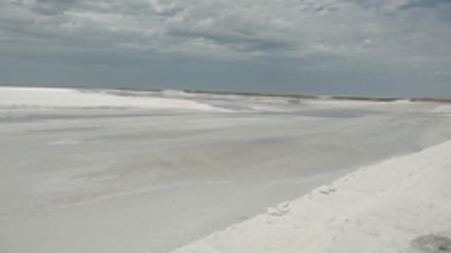 GUERRERO NEGRO BCS MEXICO-2022: Frozen Waterway with Snow Banks Under Overcast Sky