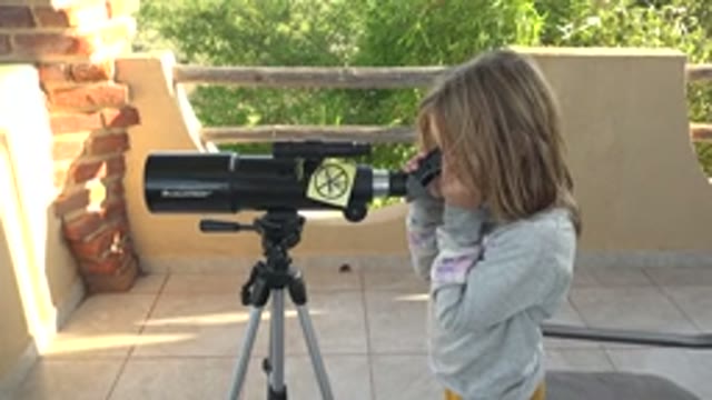SAN CARLOS BCS MEXICO-2022: Child Observing Through a Telescope on a Patio