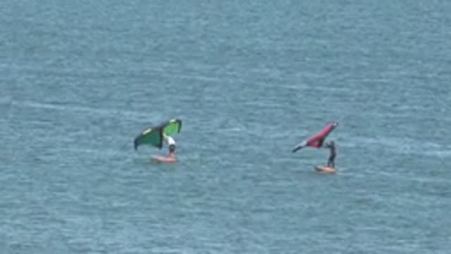 SAN JUANICO BCS MEXICO-2022: Two Wing Surfers Gliding on Calm Water