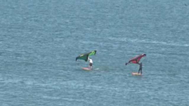 SAN JUANICO BCS MEXICO-2022: Two Kite Surfers Gliding on Calm Water