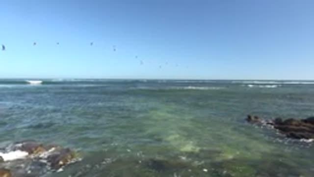 LA BOCANA BCS MEXICO-2022: Gentle Ocean Waves at Rocky Shore with Flying Seagulls