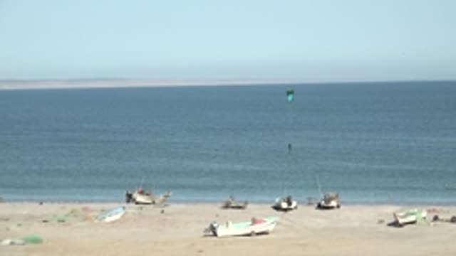 SAN JUANICO BCS MEXICO-2022: Beach with Moored Boats and Kite Surfer
