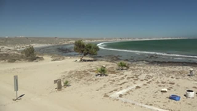 LA BOCANA BCS MEXICO-2022: Beach with Signpost and Structure Moving Out of Frame