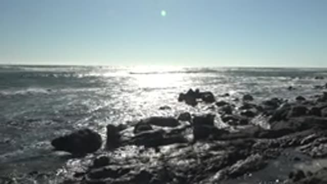 LA BOCANA BCS MEXICO-2022: Rocky Shoreline with Sunlight Glinting on Ocean Waves
