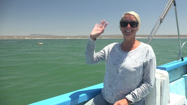 LA BOCANA BCS MEXICO-2022: Woman on a Boat Gesturing Toward the Ocean