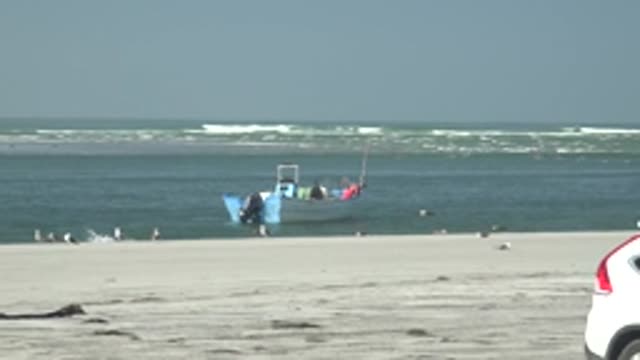 LA BOCANA BCS MEXICO-2022: White Car Driving on Sandy Beach by Ocean