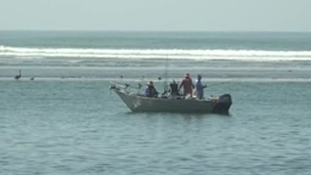 LA BOCANA BCS MEXICO-2022: People Fishing From Small Boat in Ocean